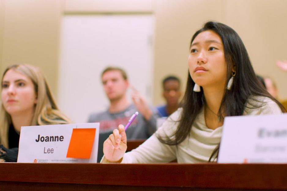 Joanne Lee sits  at table with a name tag in front of her