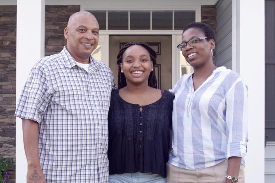 Student flanked by parents