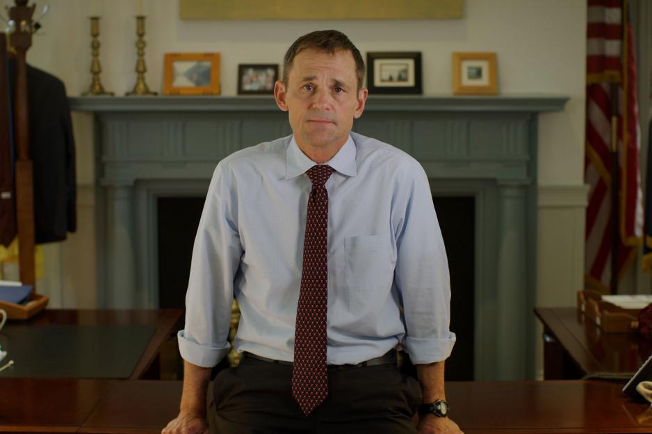 Jim Ryan standing in front of his desk