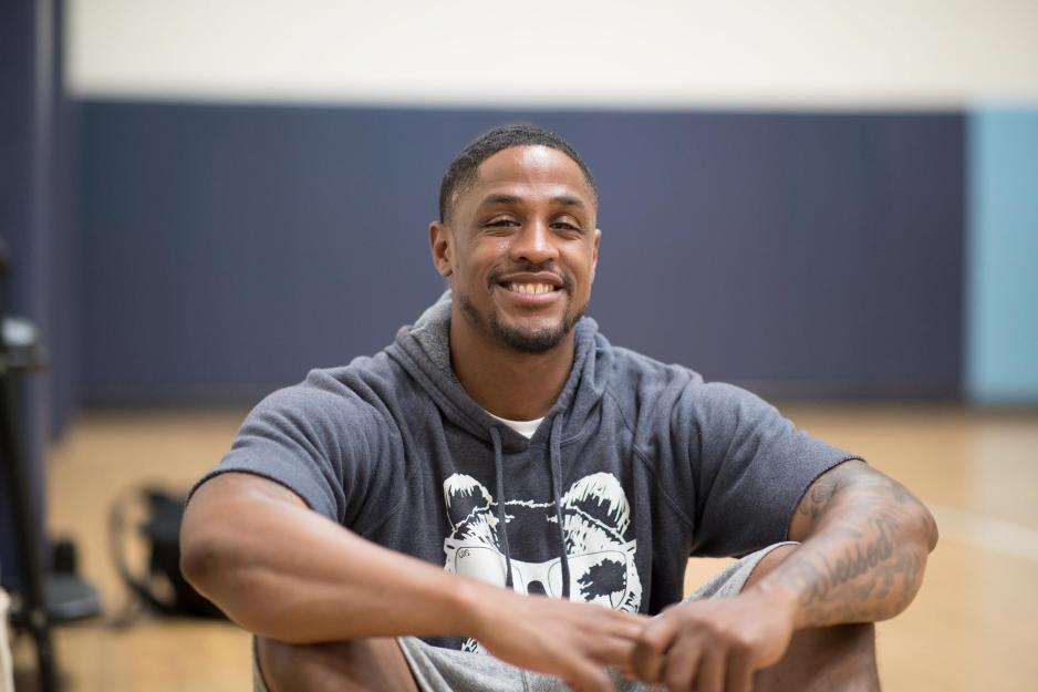 Jontel Evans sitting on a basketball court