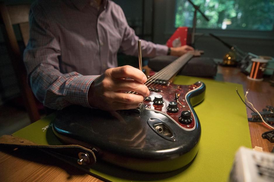 Miles Efron working on a guitar