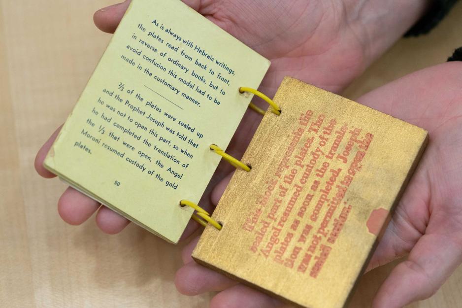 Mini book opened in a persons hands