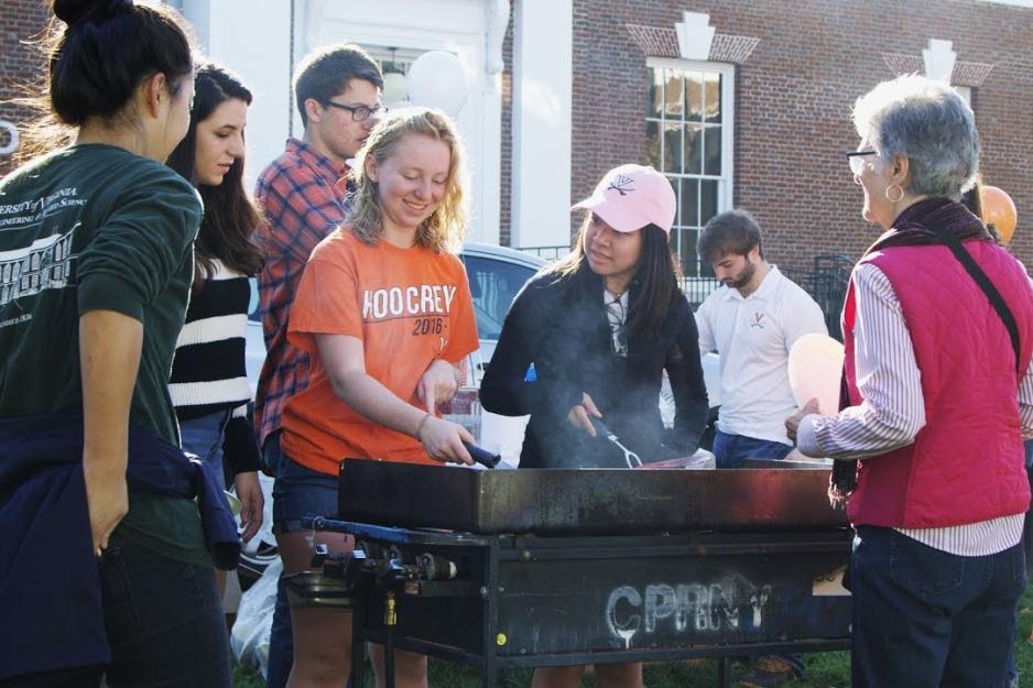 Students cooking pancakes on a griddle