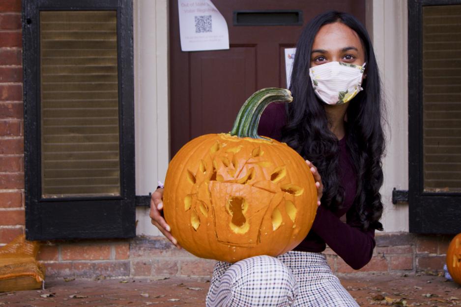 Student holding their carved pumpkin 