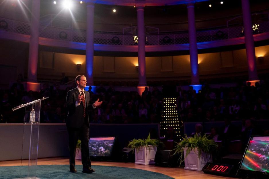 President Jim Ryan stands on a stage clapping