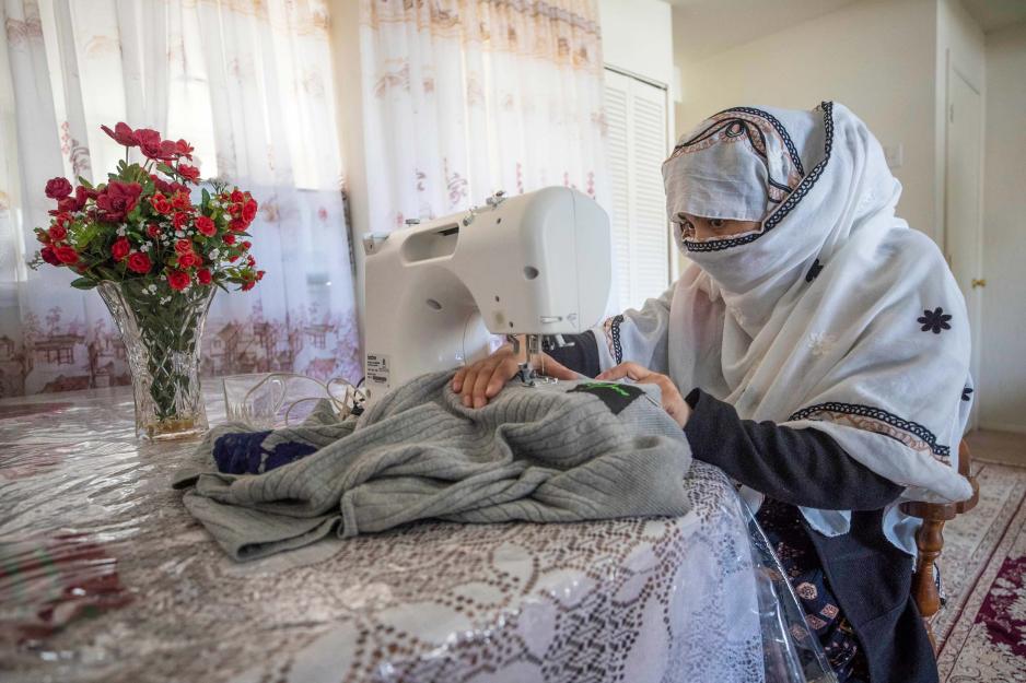 Woman sewing a sweater on a sewing machine