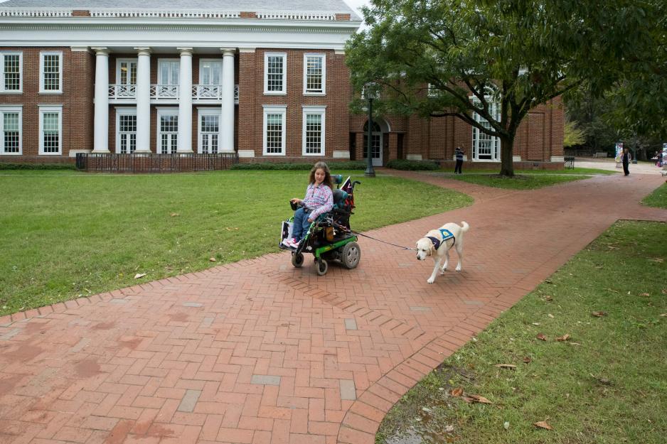 Shea Magale and service dog Pierre using a sidewalk