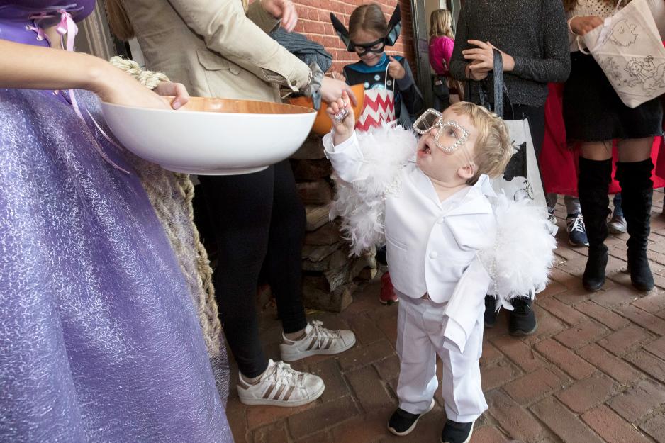 Little child trick or treating on the lawn