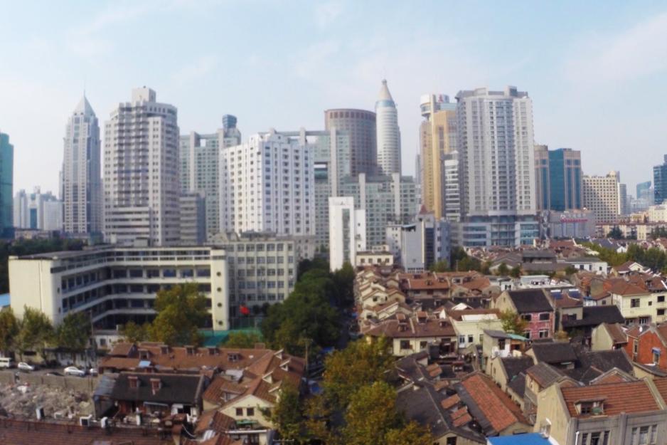 urban houses in front of skyscrapers  