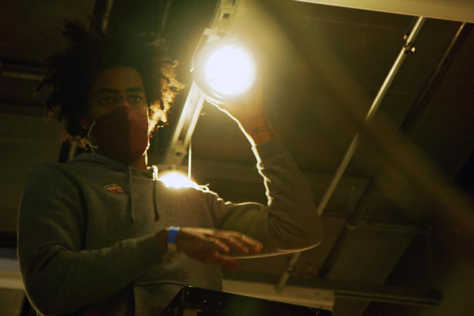 Person standing above the camera shining a bright light down towards the camera