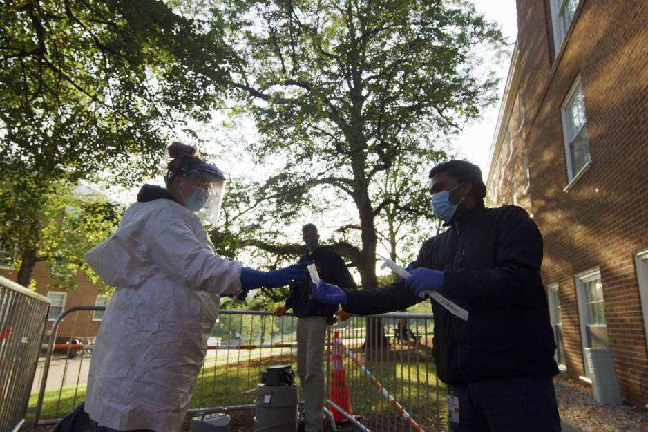UVA staff members collecting waste water samples for testing