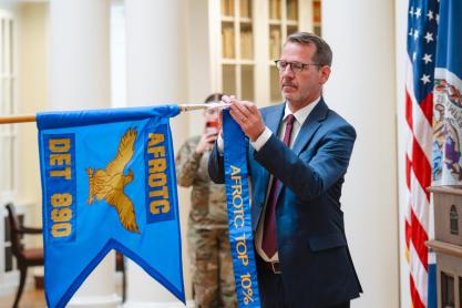 Provost Ian Baucom adds a streamer to the UVA Air Force ROTC’s flag