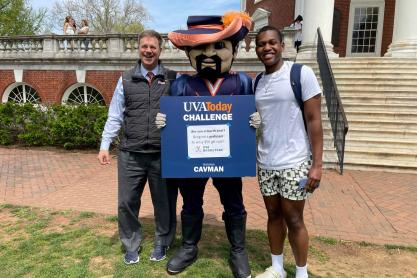 Brendan Gamor, right, poses with Cavman, middle, and professor Michael Suarez, right