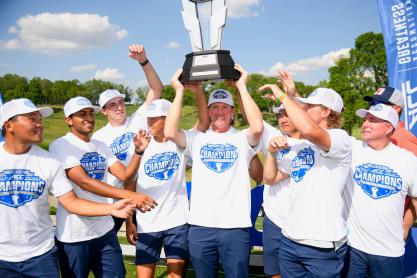 Portrait of UVA men’s golf team celebrate after winning the first ACC championship in program history.