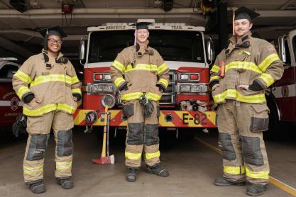 Portrait of UVA Graduate from left Takelia Jones, Kevin Holcombe and Mannix Green in fire fighter uniform.