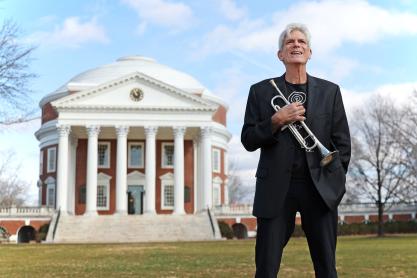 Former Director of Jazz Performance John D’earth stands with his trumpet in front of UVA’s Rotunda