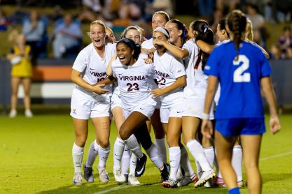 UVA women's soccer player Laney Rouse and teammates celebrate on the soccer field at Klöchner Stadium