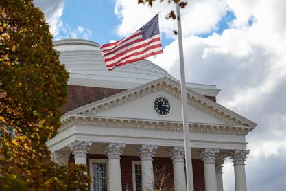 front entrance of the UVA Rotunda on an overcast afternoon with a flagpole in the foreground