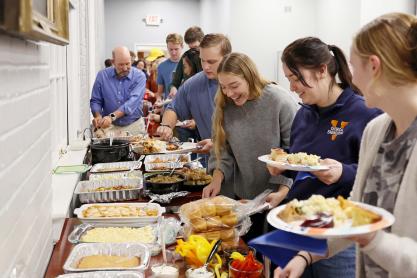 Chemical engineering students line up for food Wednesday evening at the annual Thanksgiving dinner 