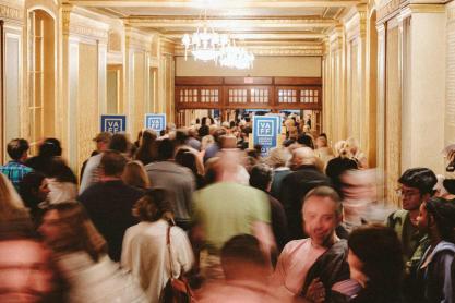 a crowd of people congregate outside the doors of the 2025 Virginia Film Festival