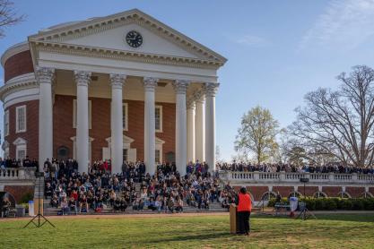 Dozens of students sit on the steps of the UVA Rotunda, as Robyn Hadley addresses them from a podium on the Lawn