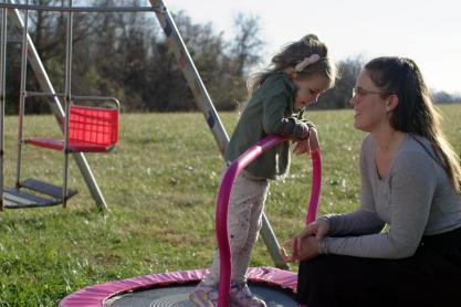 A little girl playing with her mother at a playground