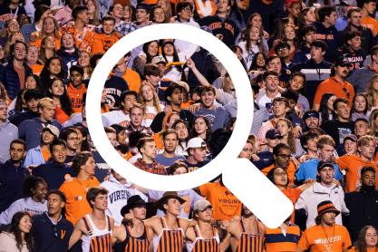 Magnifying glass illustration over a photo of the UVA students at a home football game.