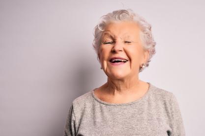 An elderly lady laughing