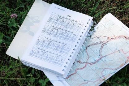 An open notebook on top of a map