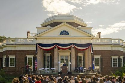 President Ryan on a stage in front of Monticello addressing the audience.