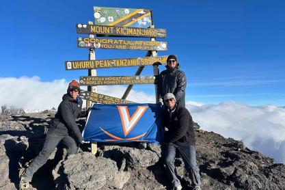 Kevin Lee, James Edwards and Tommy McNeal hold a UVA flag at the summit of Mt. Kilimanjaro