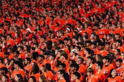 Students in the stand at Scott Stadium dressed in all orange