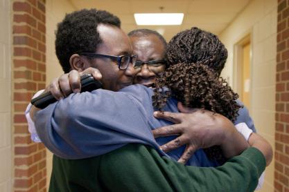 A family embraces in an emotional hug