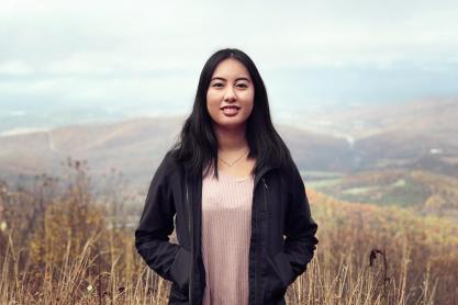 Anna Nguyen headshot on top of a mountain