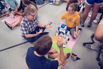 Keith Williams, left, works with other students and their robots