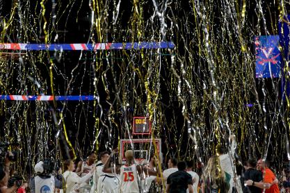 Yellow and white streamers fall on to the basketball court after UVA wins