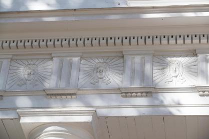 Apollo heads on the entablature on Pavilion one
