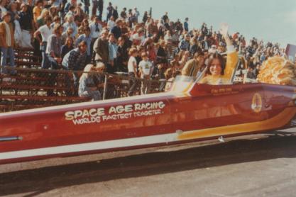 Vintage photo of Kitty O'Neil sitting in Dragster car