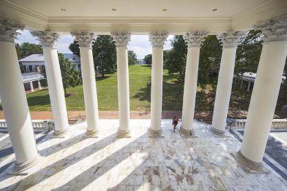 Arial view from inside of the Rotunda looking down at a student walking up the steps of the Rotunda