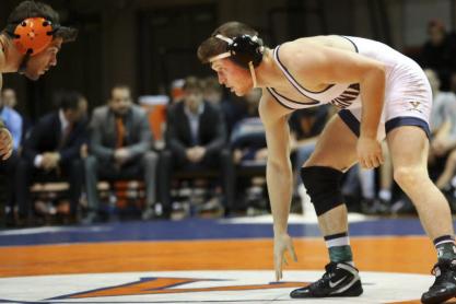 Sam Martino in UVA wrestling uniform bent over preparing to engage opponent