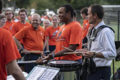 President Jim Ryan plays a snare drum 