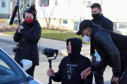 Canaan Severin, looking at the camera with the camera man and crew