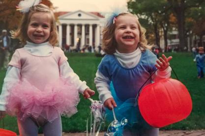 Two blonde little girls in matching fairy costumes.
