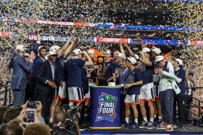 Confetti falling from they sky while UVA's basketball team celebrates on the Final Four stage