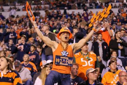 Som Patasomcit decked out in UVA gear screaming during a football game