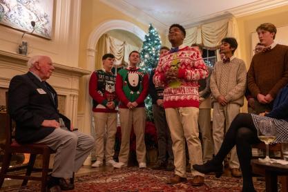 Jack Bertram watches as the UVA Virginia Gentlemen sing holiday tunes