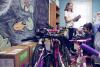 Madison House student volunteers with the Holiday Sharing program Ally Bollettino, left, and Salwa Malik check on new bicycles for local children. (Photos by Dan Addison, University Communications)