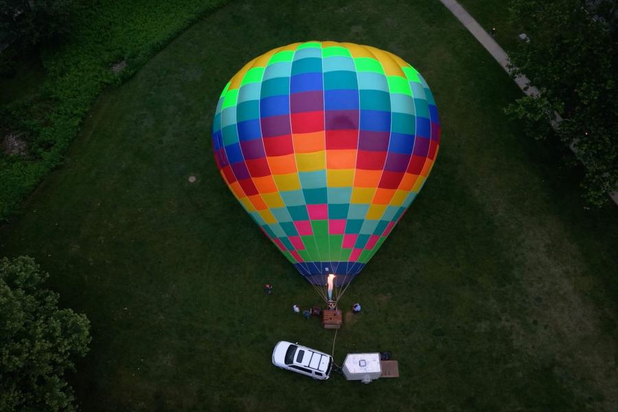 a hot air balloon being retrieved by chasers