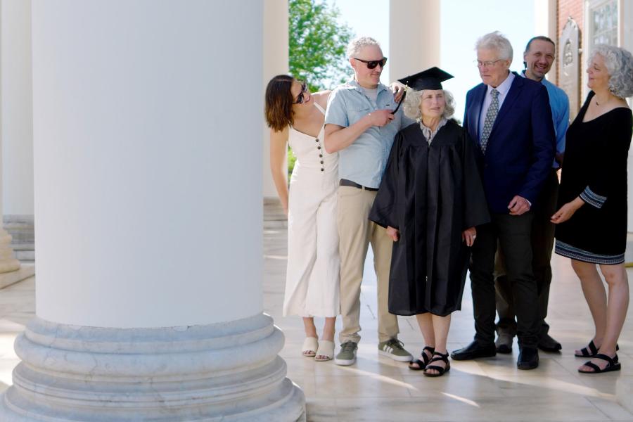 Mary Ann Parr with her cap and gown, surrounded by people
