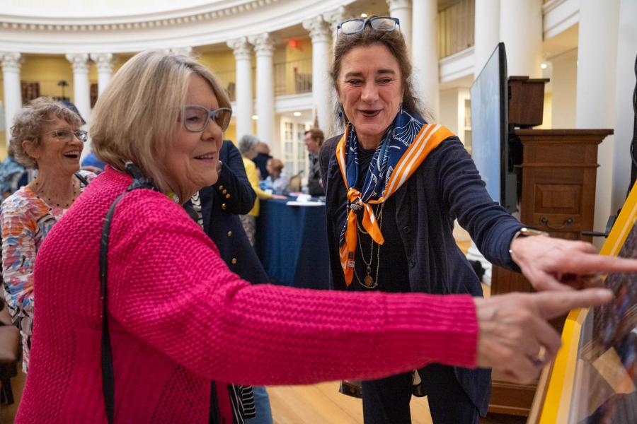 Karen Skole, left, and Dickie McMullan point to themselves in the official reunion photograph of their class 